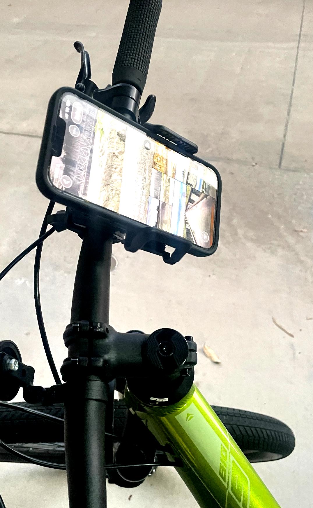 Smartphone mounted on a bicycle handlebar with a reflective screen
